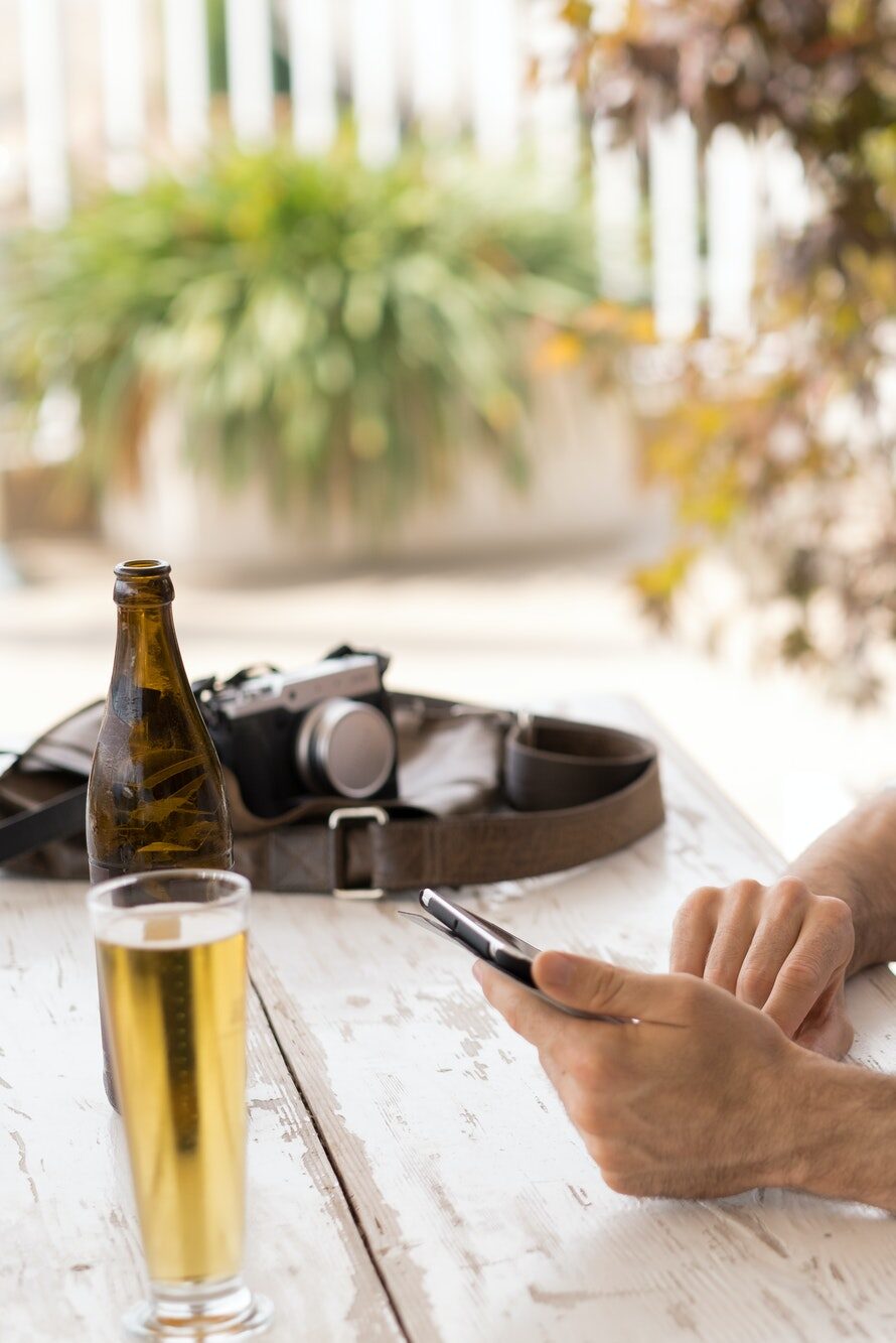 Web designer with camera and beer